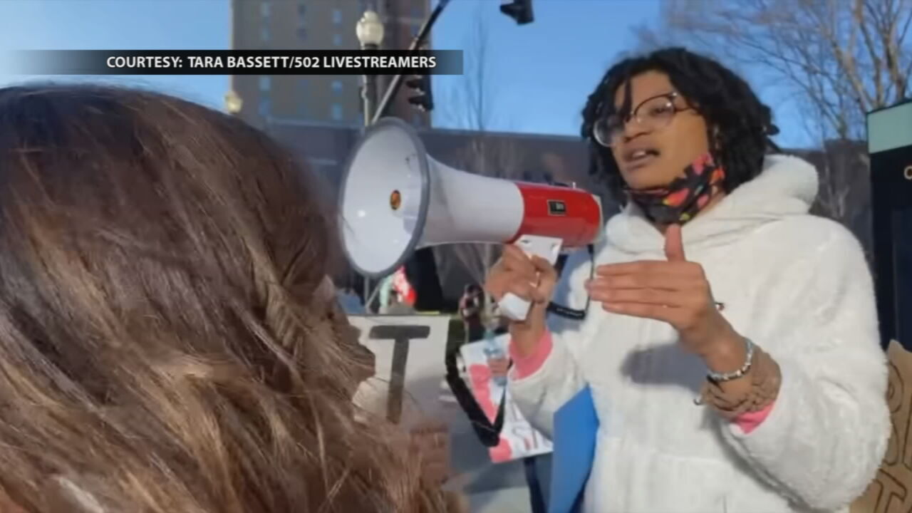 Carmen M. Jones, right, talks with a woman at a protest